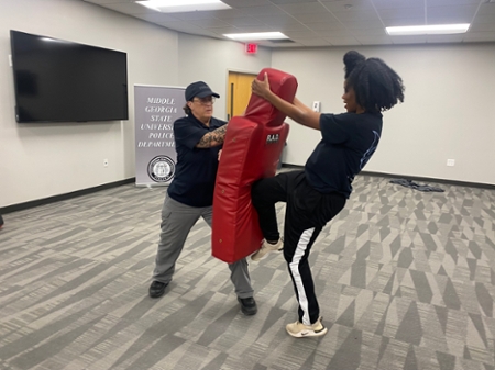 Student practicing self-defense training during the Macon Campus R.A.D. course..